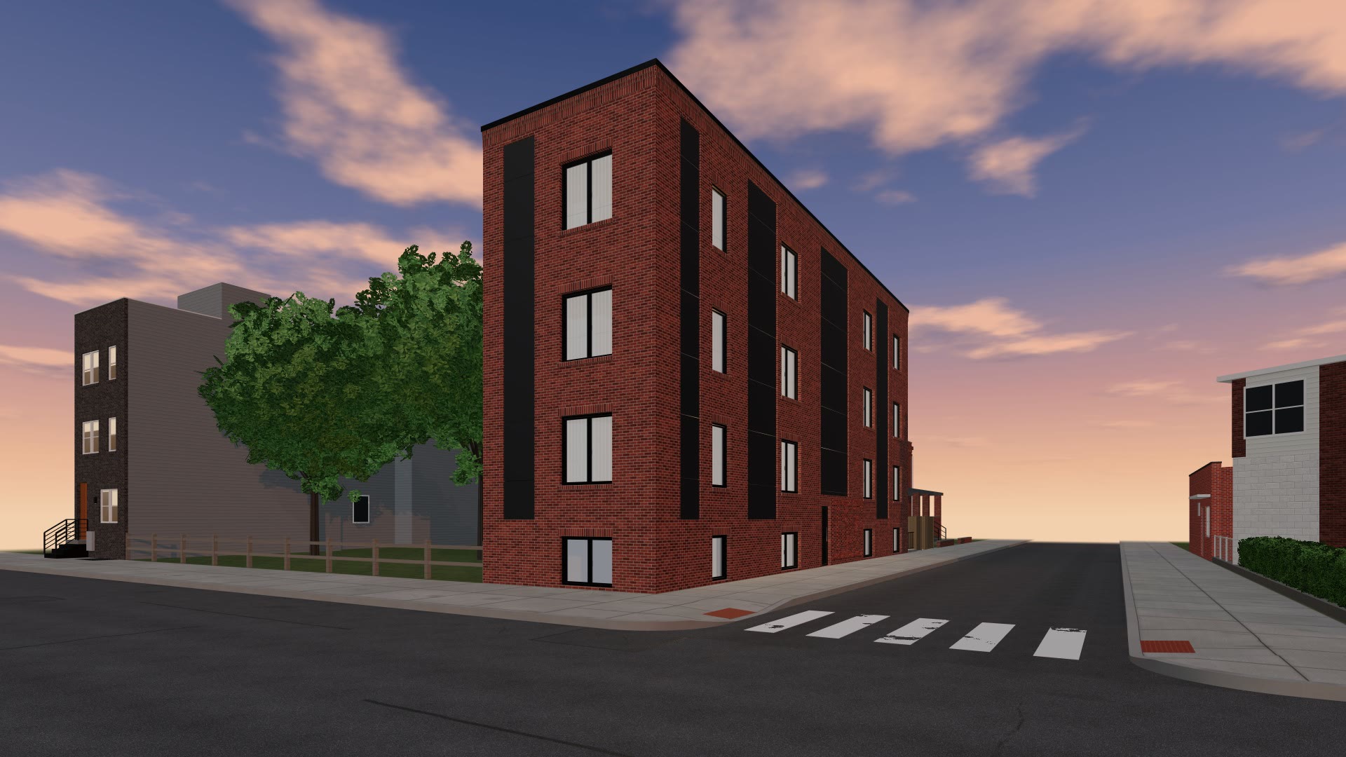 A three-story red brick corner building at dusk